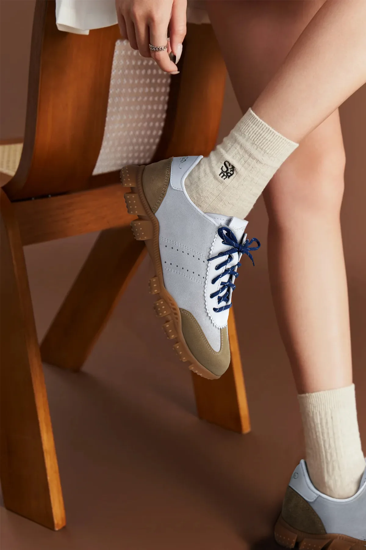 Close-up of a laced sneaker on a wooden chair