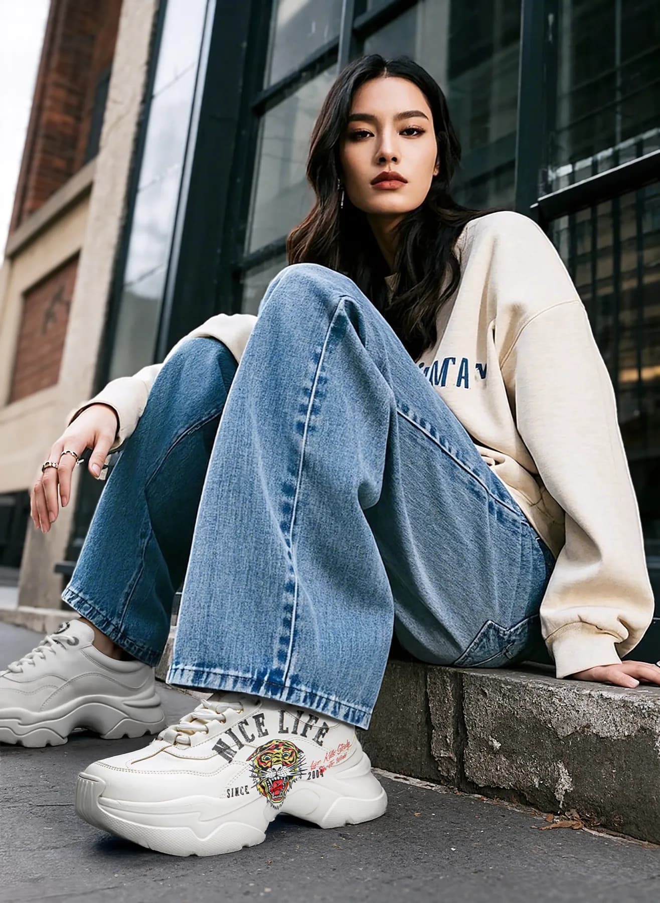 Model on a city curb in chunky sneakers